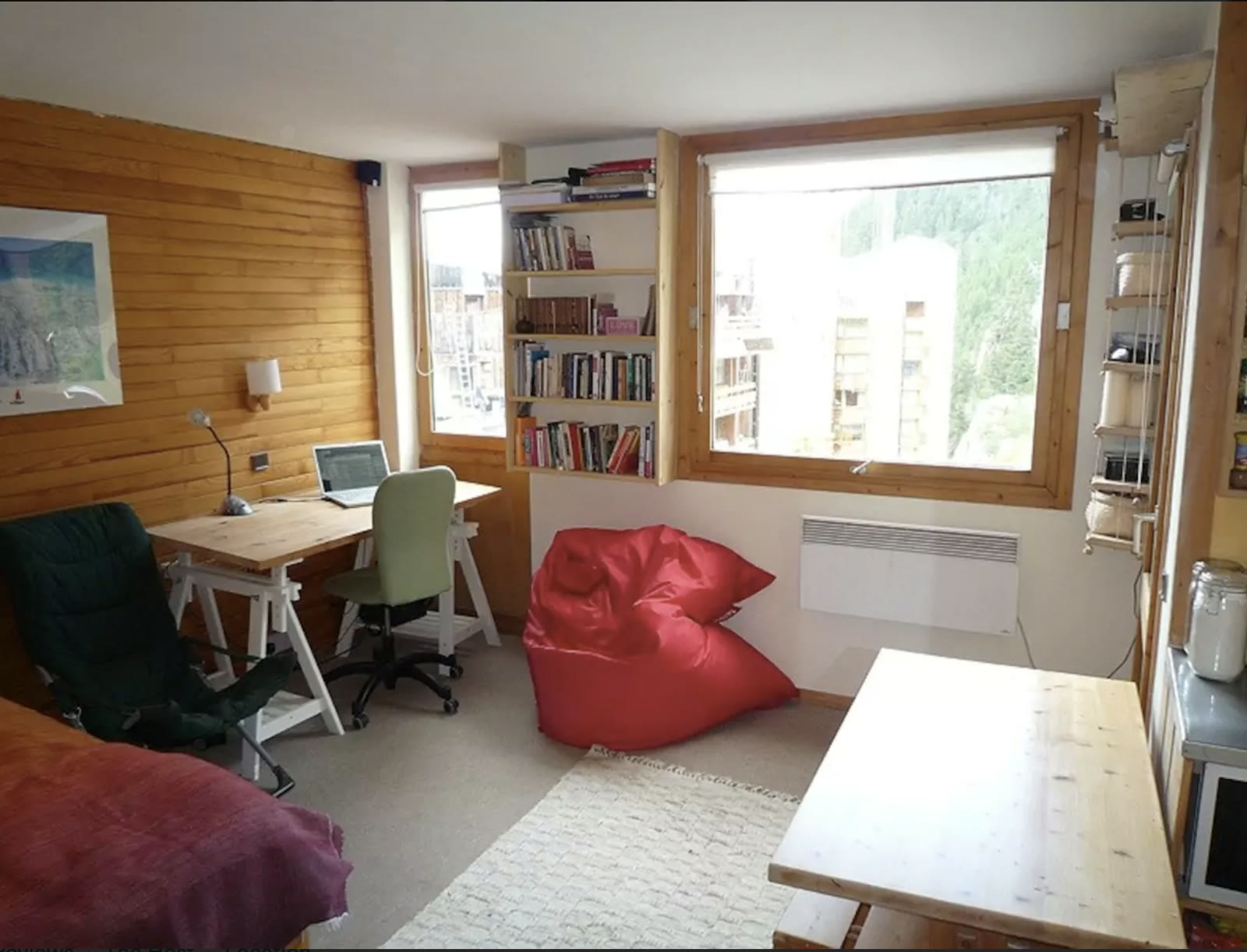 Living area with the dining table, windows and mountain view